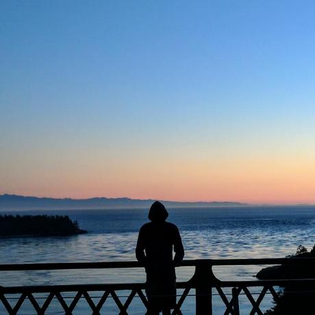 John Palenchar, silhouetted against the water at dusk
